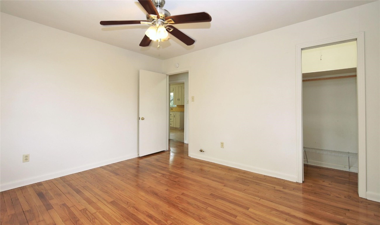 108 West Mink Street Willis, TX 77378 - Photo 12 of 12 an empty room with wooden floor a ceiling fan and entryway