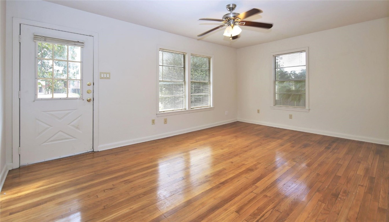 108 West Mink Street Willis, TX 77378 - Photo 2 of 12 a view of empty room with wooden floor and fan