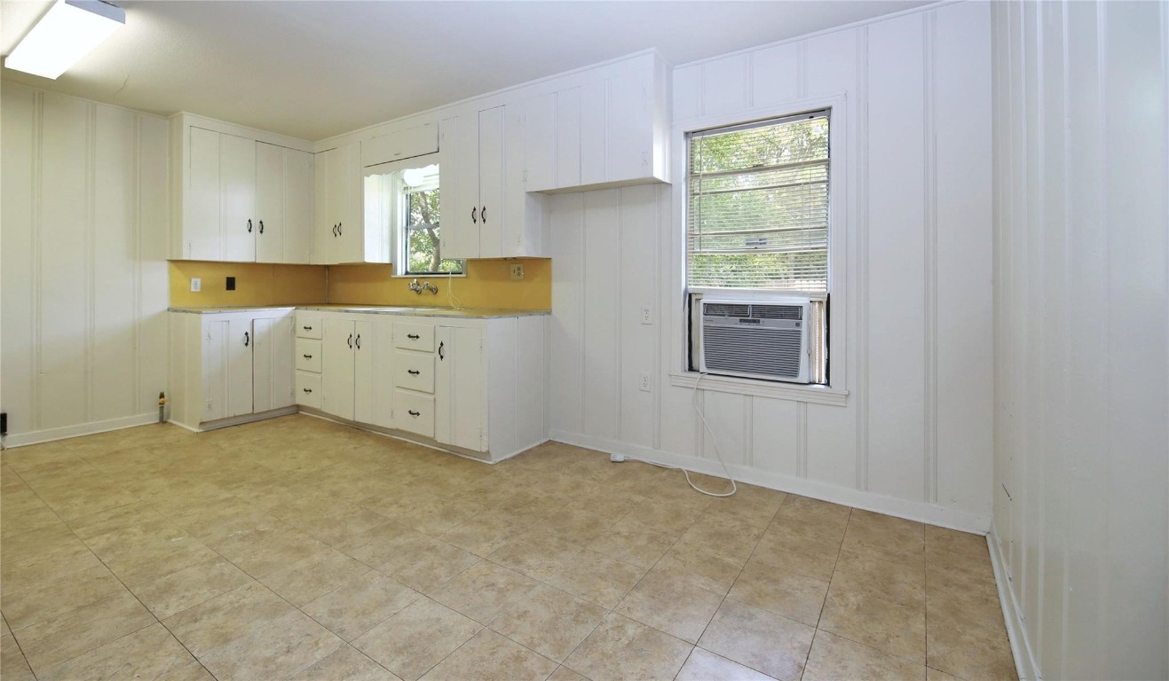 108 West Mink Street Willis, TX 77378 - Photo 3 of 12 a kitchen with cabinets appliances and a window