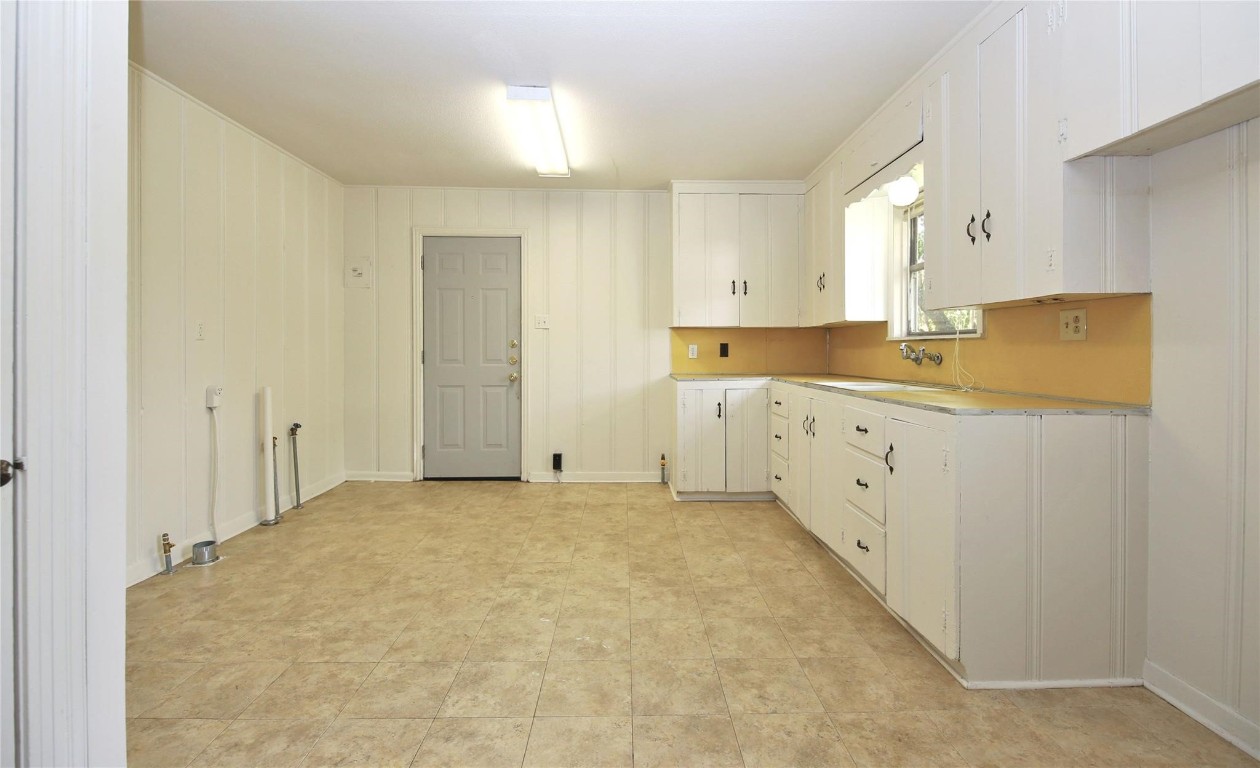108 West Mink Street Willis, TX 77378 - Photo 4 of 12 a view of a kitchen with white cabinets