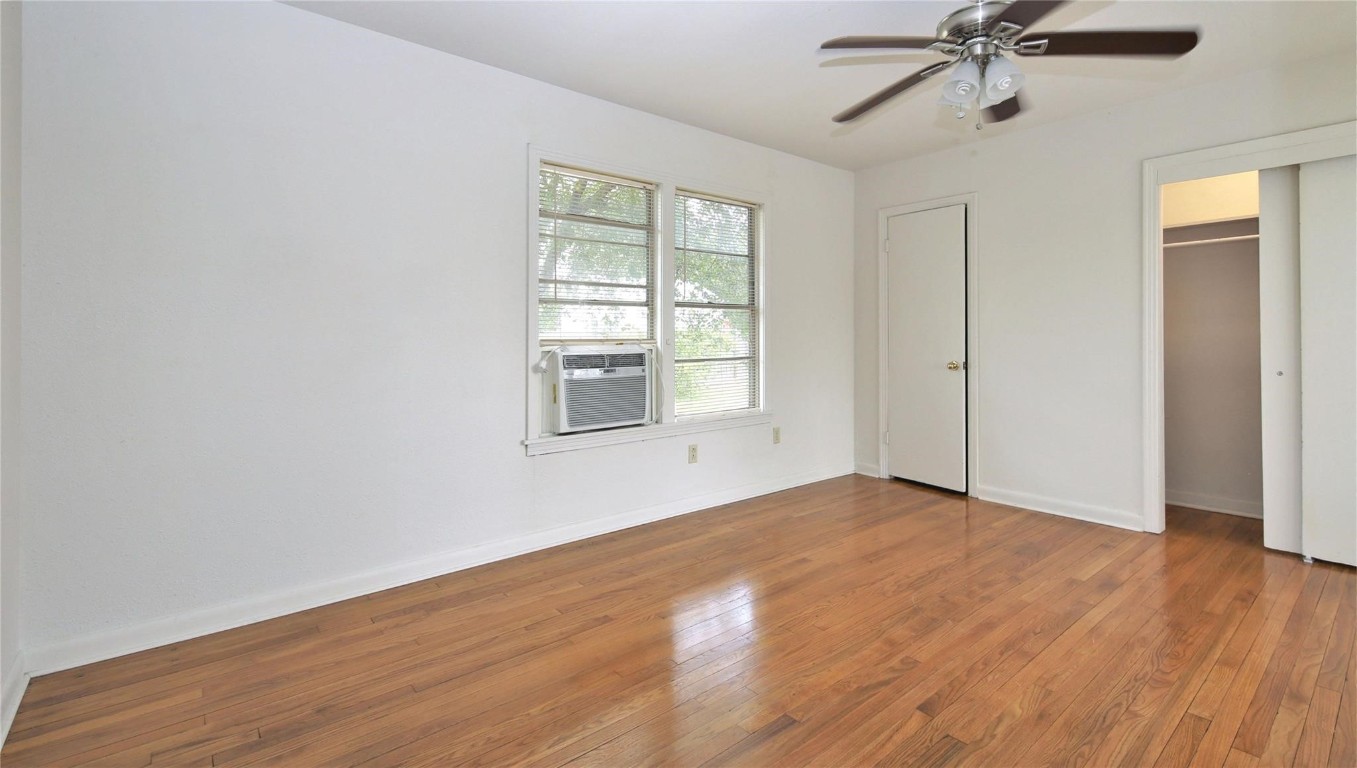 108 West Mink Street Willis, TX 77378 - Photo 8 of 12 a view of an empty room with wooden floor and a window