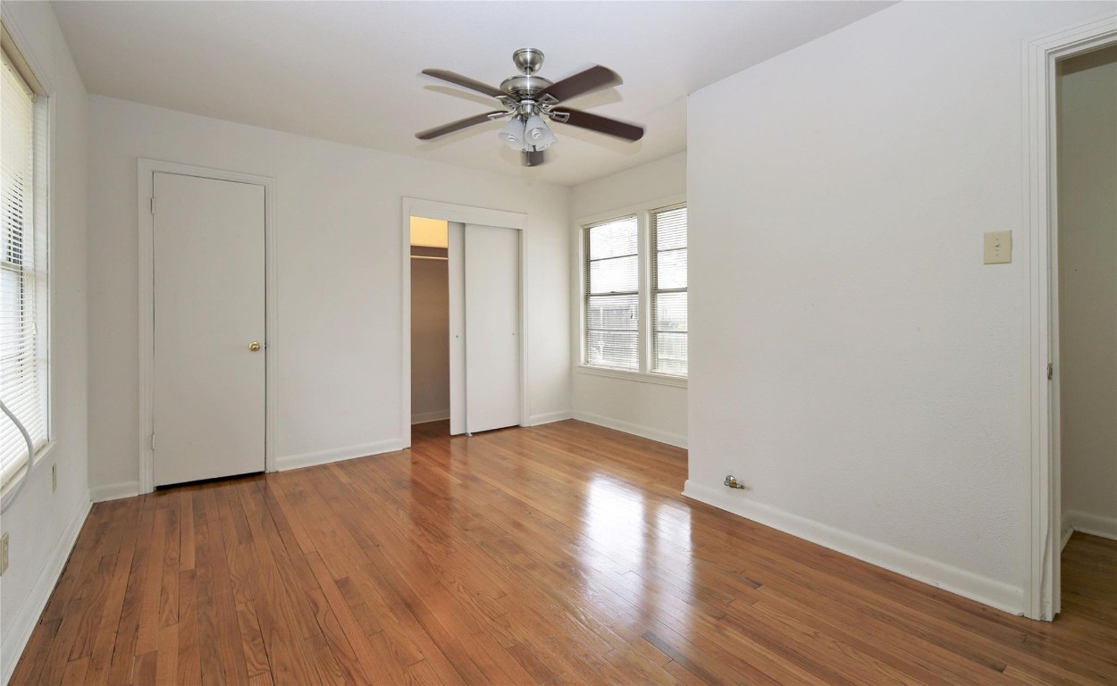 108 West Mink Street Willis, TX 77378 - Photo 9 of 12 an empty room with wooden floor and windows