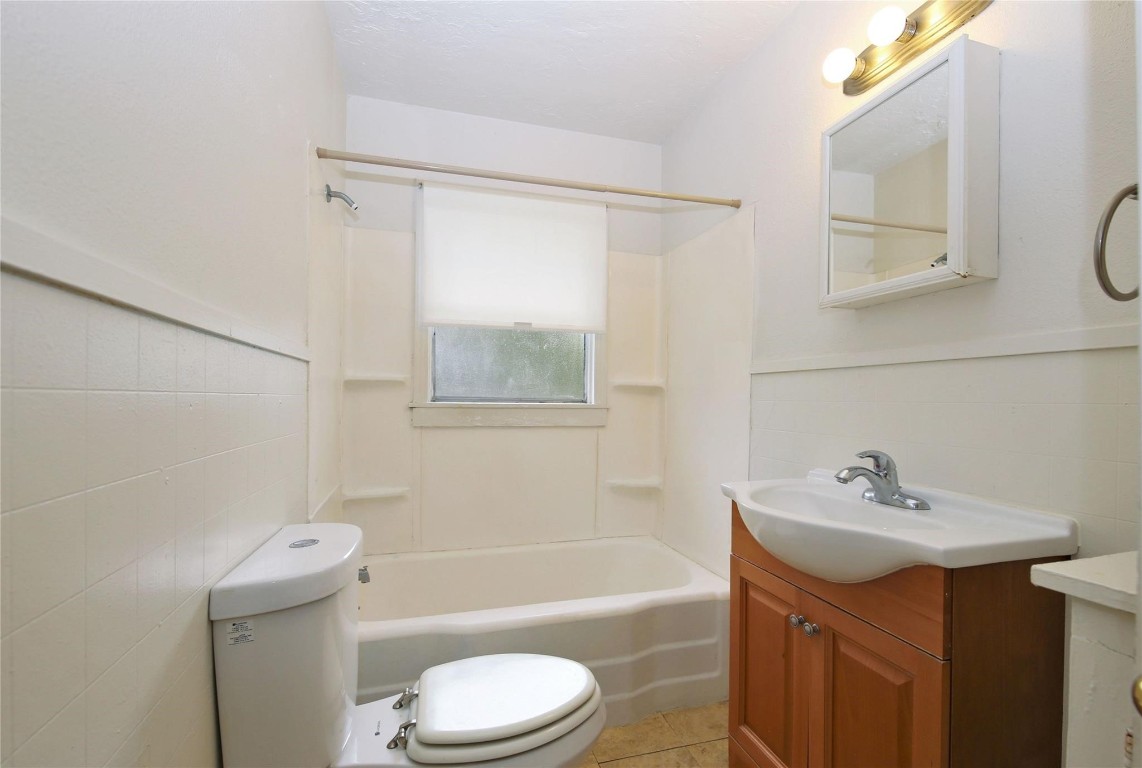 108 West Mink Street Willis, TX 77378 - Photo 10 of 12 a bathroom with a sink a toilet and shower