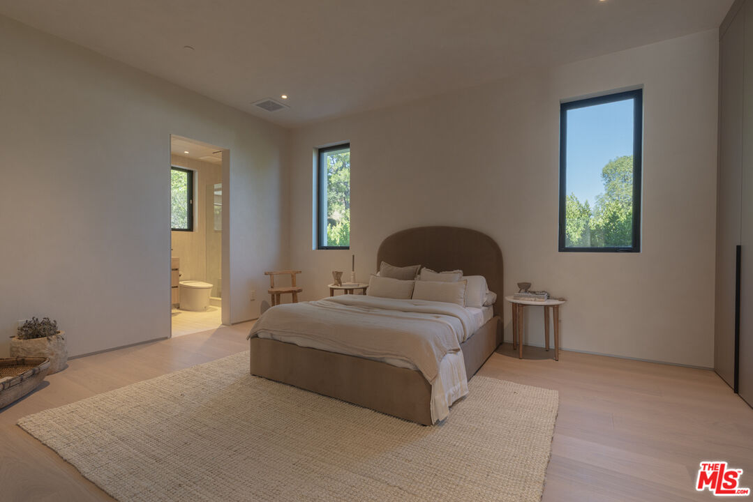 17177 Adlon Road Encino, CA 91436 - Photo 15 of 21 a bedroom with a bed and a window