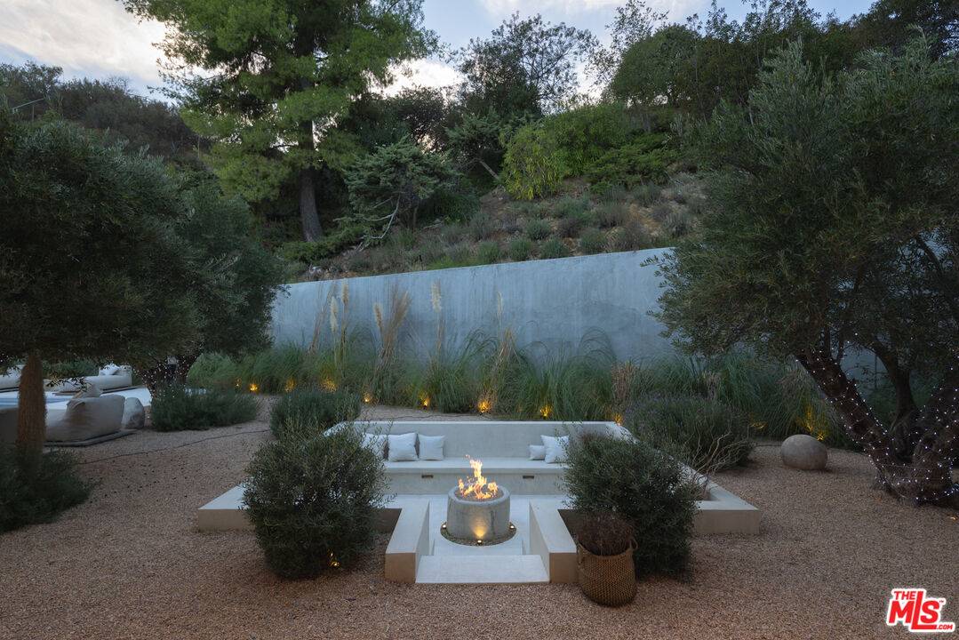 17177 Adlon Road Encino, CA 91436 - Photo 20 of 21 a view of a chairs and table in the backyard