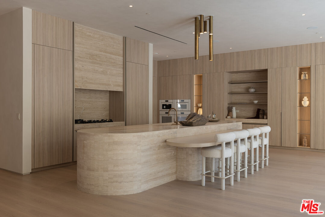 17177 Adlon Road Encino, CA 91436 - Photo 7 of 21 a kitchen with kitchen island a sink a stove and a refrigerator