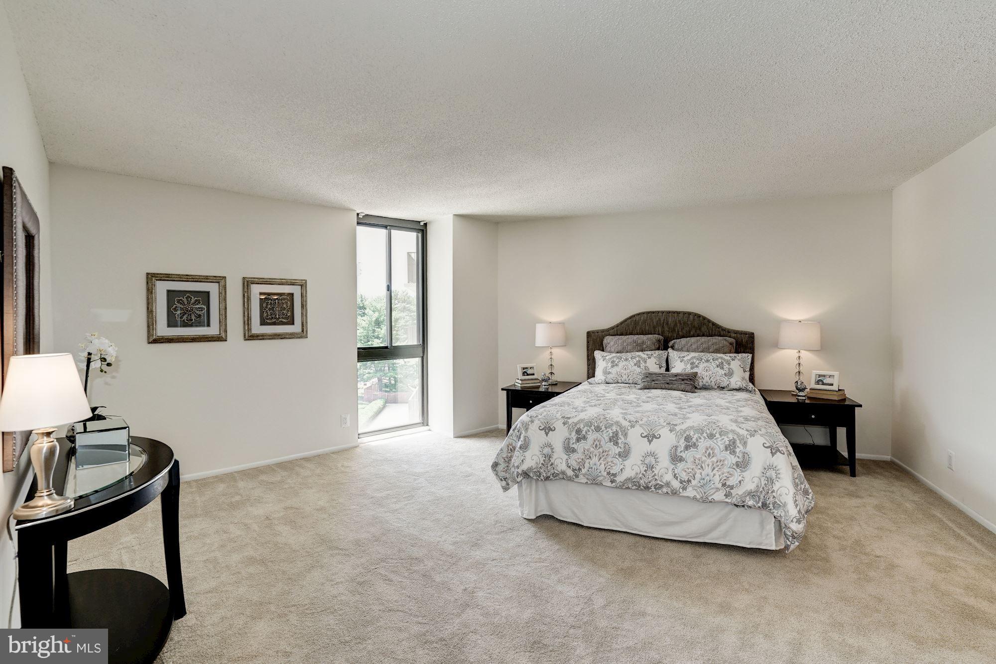 6800 Fleetwood Road, Unit 610 McLean, VA 22101 - Photo 12 of 26 a bedroom with a bed and a lamp on table