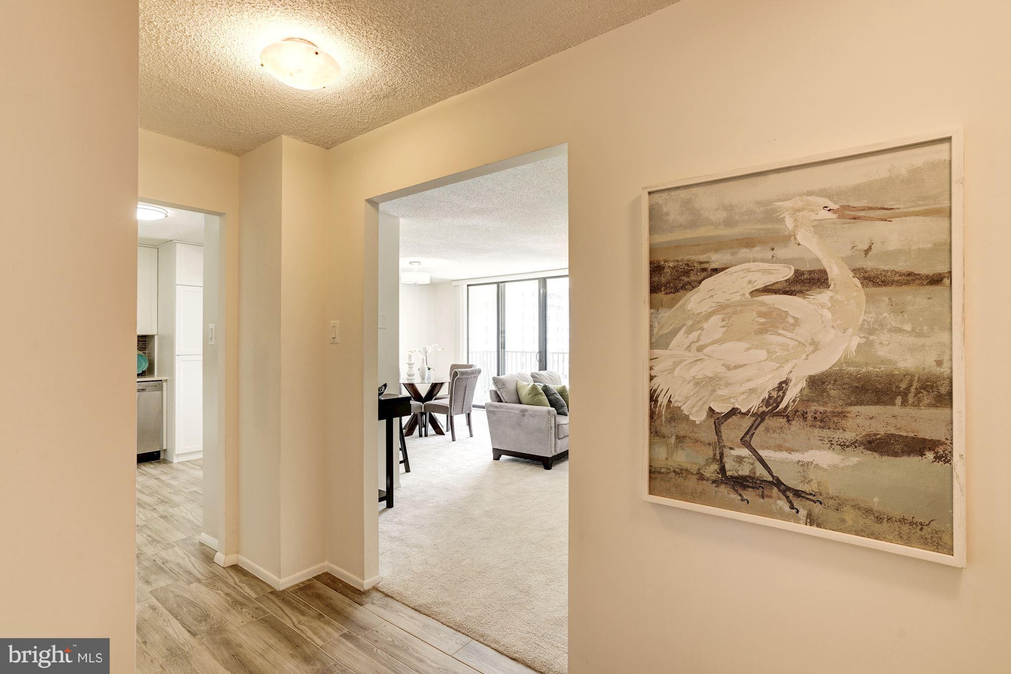 6800 Fleetwood Road, Unit 610 McLean, VA 22101 - Photo 3 of 26 a view of a hallway with wooden floor and a living room