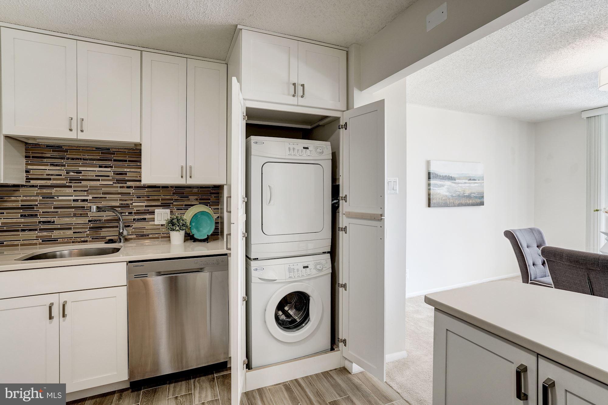 6800 Fleetwood Road, Unit 610 McLean, VA 22101 - Photo 5 of 26 a kitchen with stainless steel appliances white cabinets and a refrigerator
