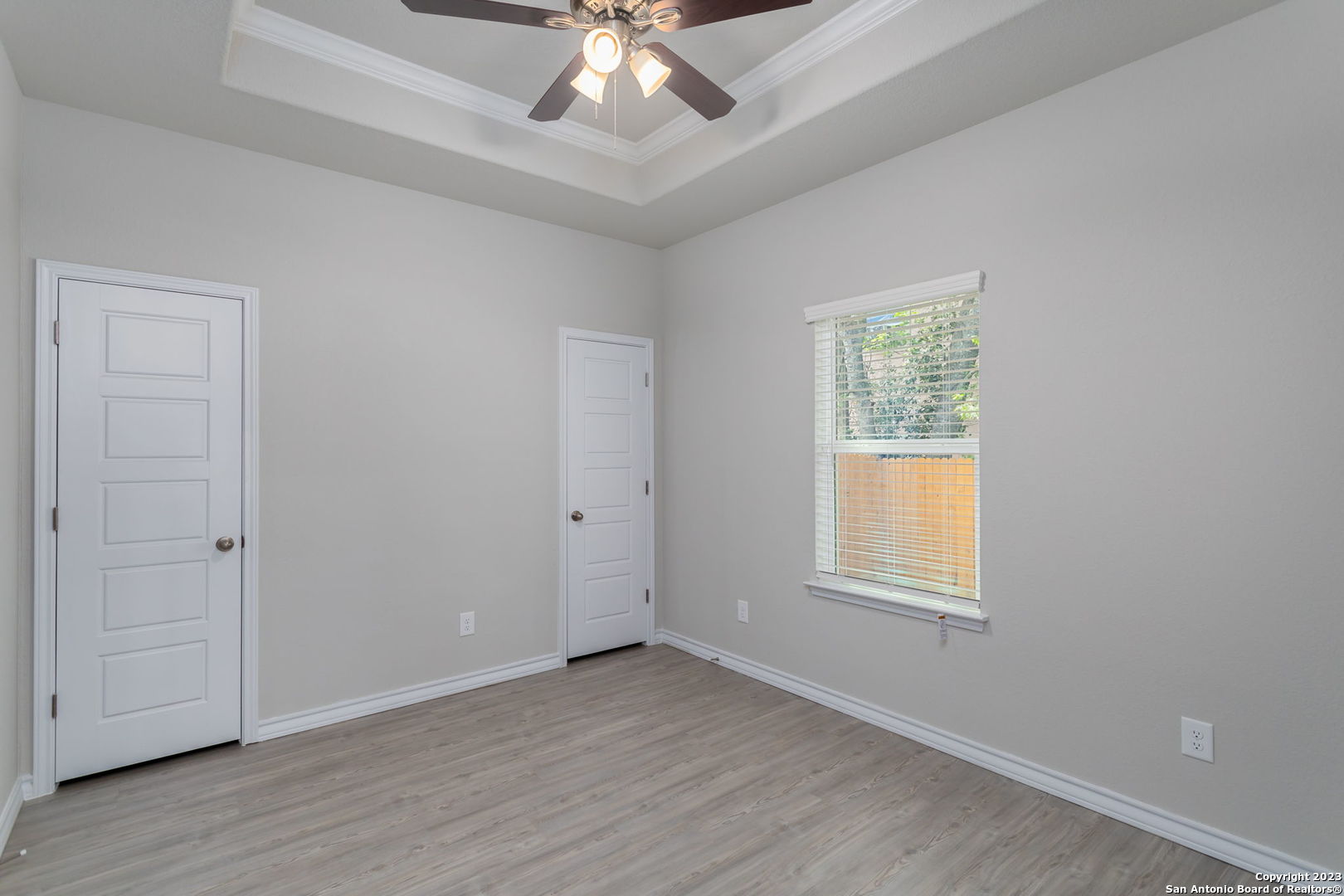 402 Trefger Street Seguin, TX 78155 - Photo 6 of 10 an empty room with wooden floor and windows