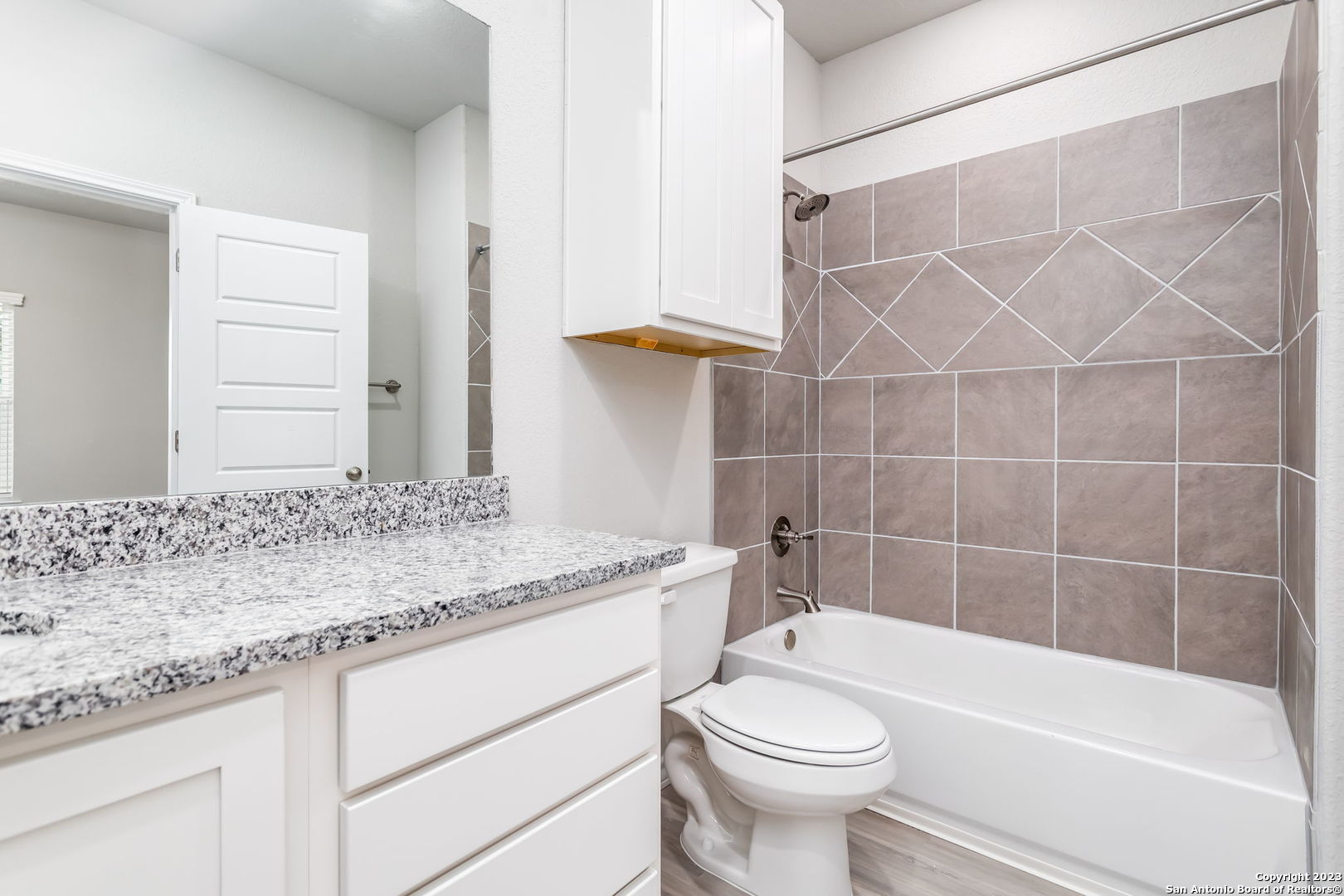 402 Trefger Street Seguin, TX 78155 - Photo 9 of 10 a bathroom with a granite countertop bathtub sink vanity mirror and toilet
