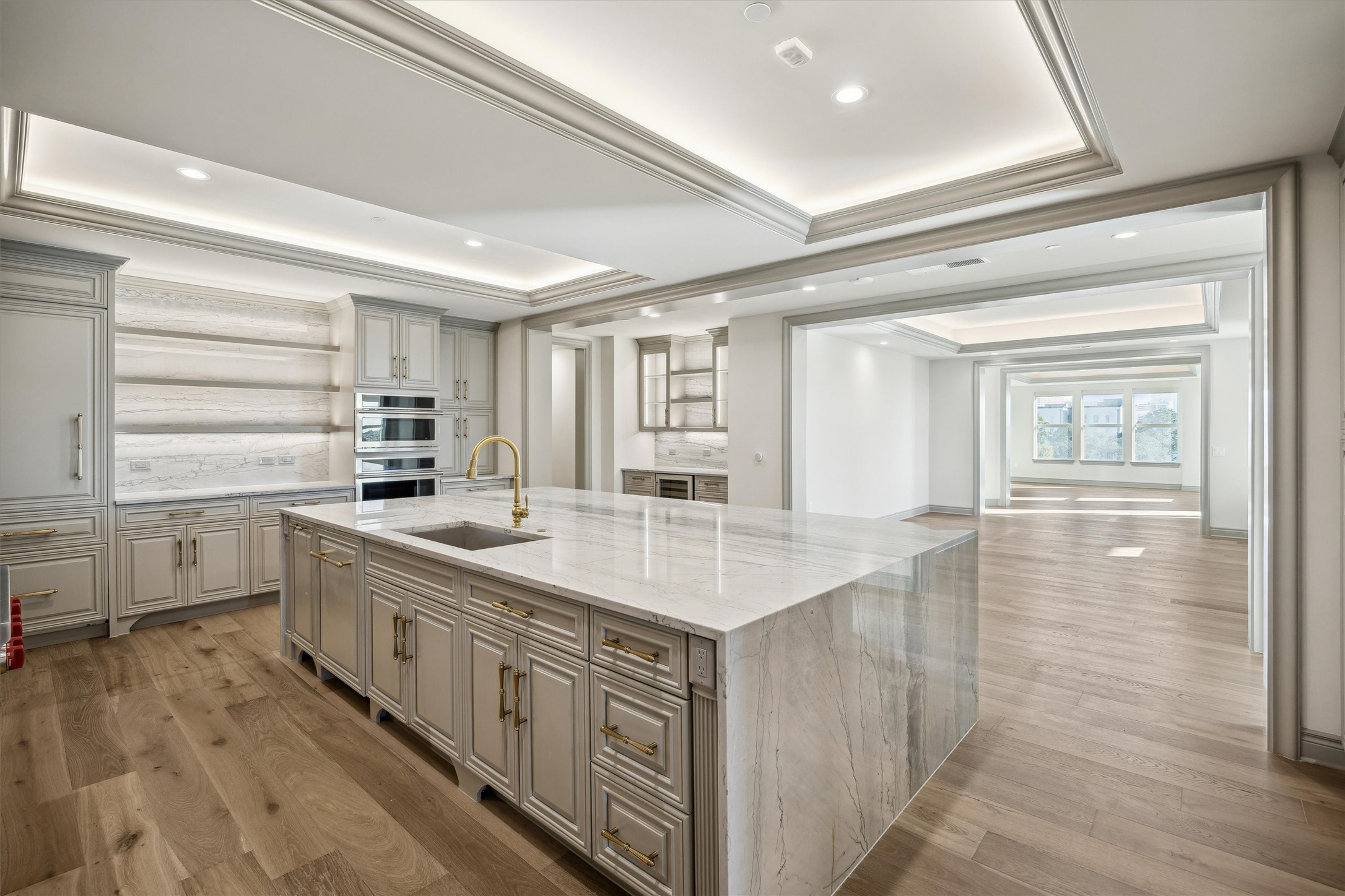 1717 Bissonnet Street, Unit 1802 Houston, TX 77005 - Photo 4 of 46 Beautiful wide plank hardwood floors throughout, Quartzite waterfall island and counters, built-in panel front refrigerator and dishwasher.
