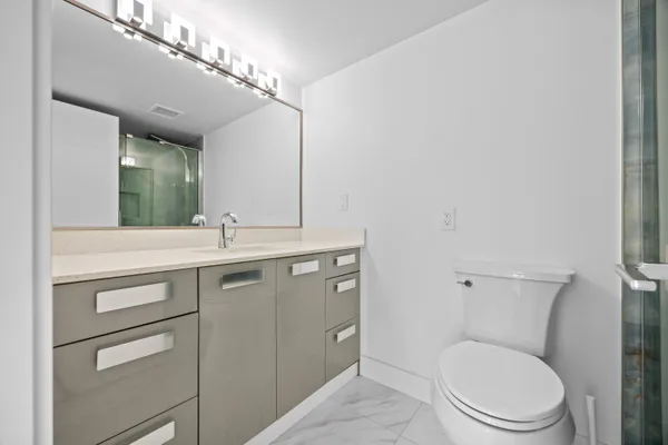 a bathroom with a toilet and a shower