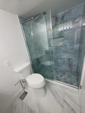 a view of an empty room and a bathroom