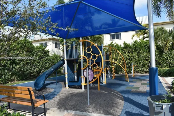 a view of a patio with table and chairs under an umbrella
