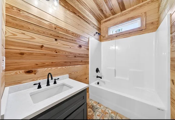 a bathroom with a bathtub and sink
