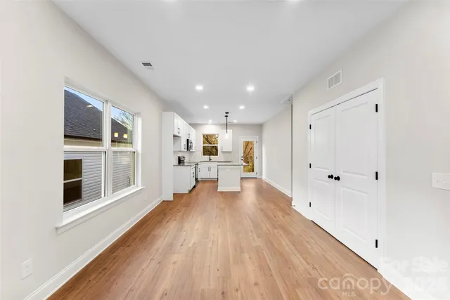 a view of a living room with wooden floor