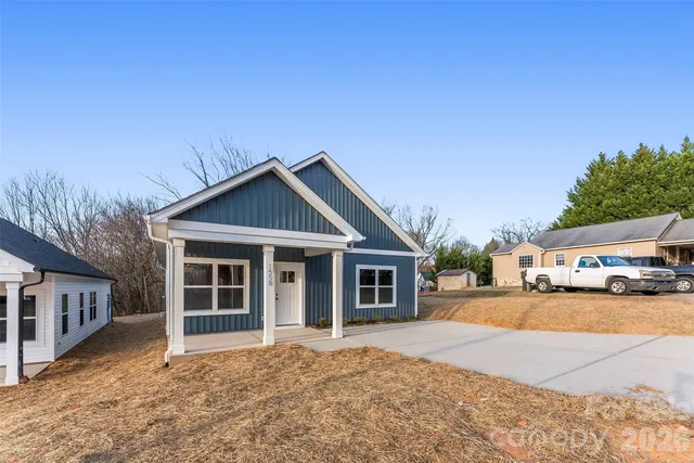 a view of a house with a yard and garage