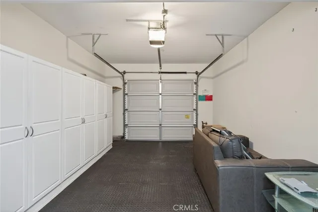 a view of a bedroom with wooden floor and windows
