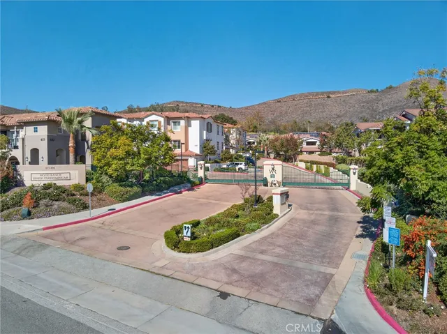 a view of a patio with couches and table potted plants and palm trees