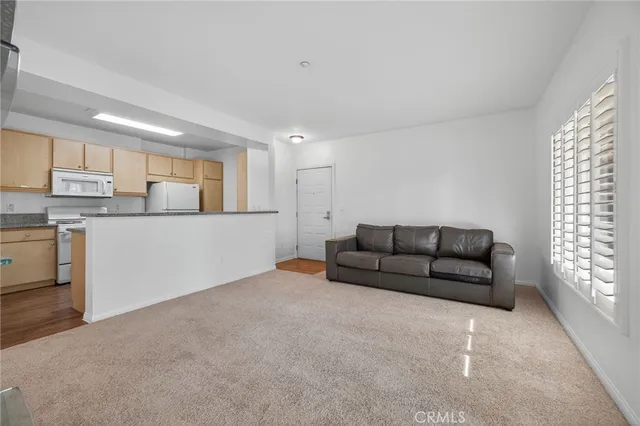a kitchen with cabinets appliances a sink and a window