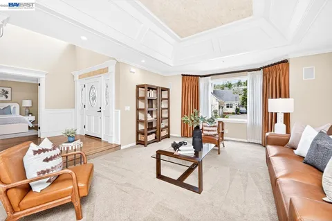 a living room with furniture and a floor to ceiling window