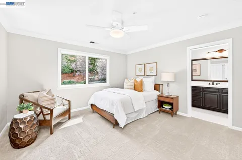 a spacious bedroom with a bed and a chandelier