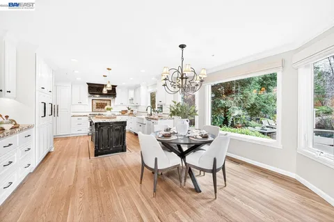 a kitchen with stainless steel appliances granite countertop a stove and a microwave