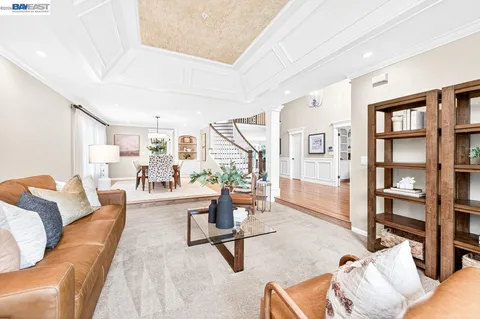 a living room with furniture and a book shelf