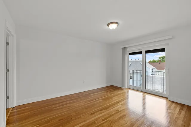 a view of an empty room with glass door