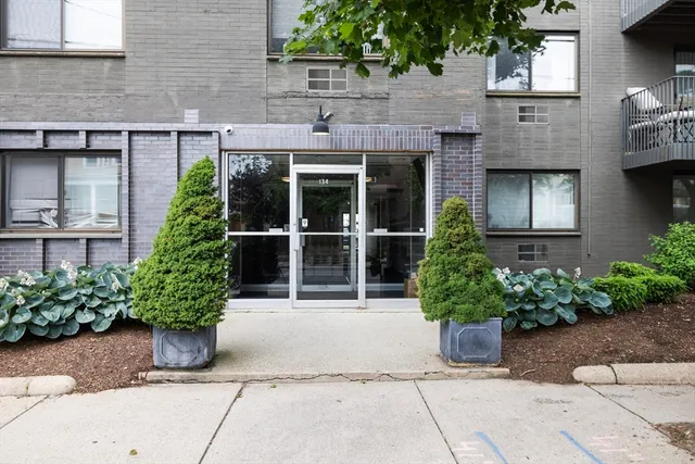 a view of a building with potted plants