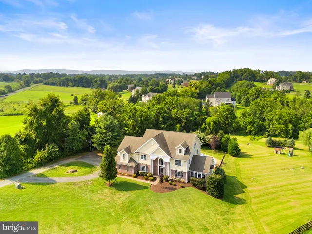 an aerial view of a house with garden space and ocean view