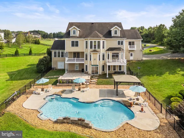 an aerial view of a house with swimming pool garden and balcony