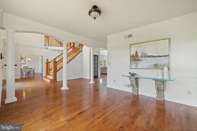 an empty room with windows and ceiling fan