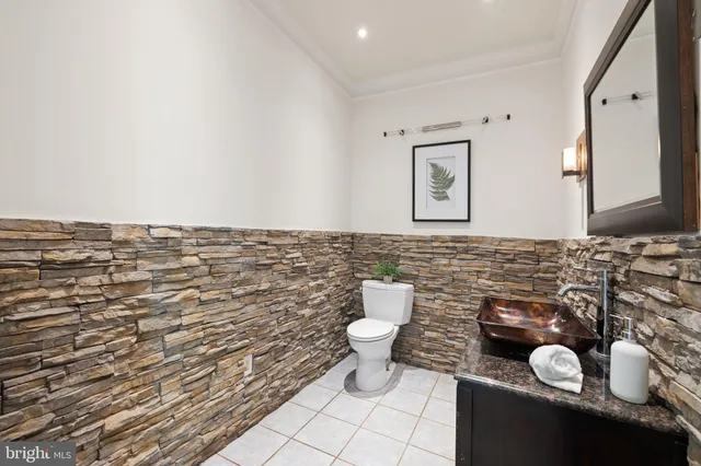 a bathroom with a granite countertop sink a toilet and a bathtub