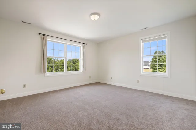 a kitchen with kitchen island granite countertop a stove a sink a refrigerator and wooden floor