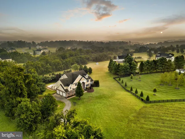 an aerial view of a house with a lake view