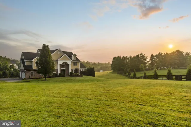 a living room with furniture a fireplace and a floor to ceiling window