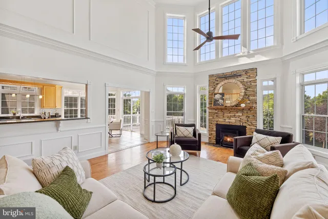 a view of a dining room with furniture a kitchen and chandelier