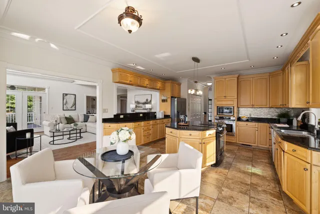 a open kitchen with stainless steel appliances granite countertop a sink and cabinets