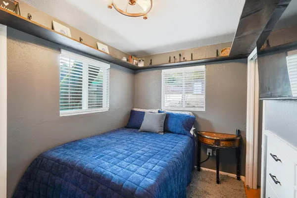 a bedroom with a bed and a window