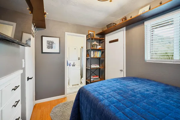a bedroom with a large bed and a window