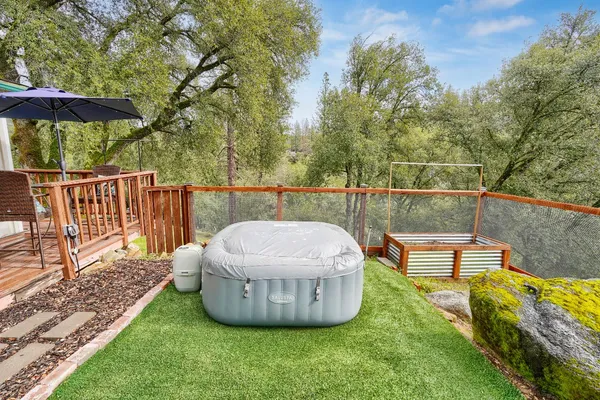 a view of a roof deck with couches and wooden fence