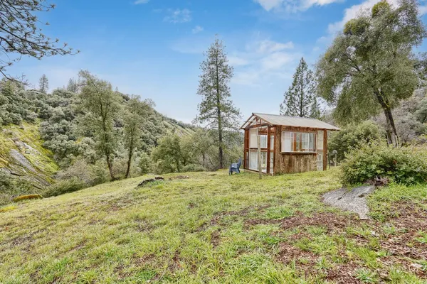 a yellow house with trees in front of it