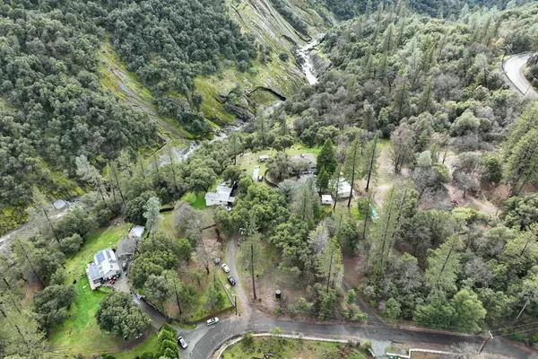 an aerial view of residential house with outdoor space and trees