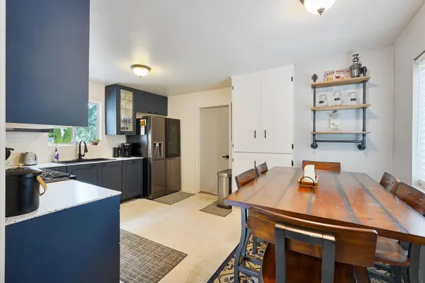 a kitchen with a refrigerator a sink a stove and cabinets