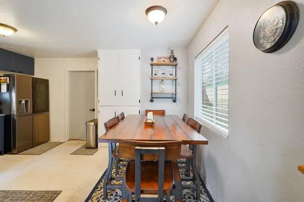a room with a table and a chandelier