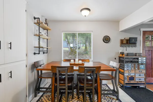 a view of a dining room with furniture and window