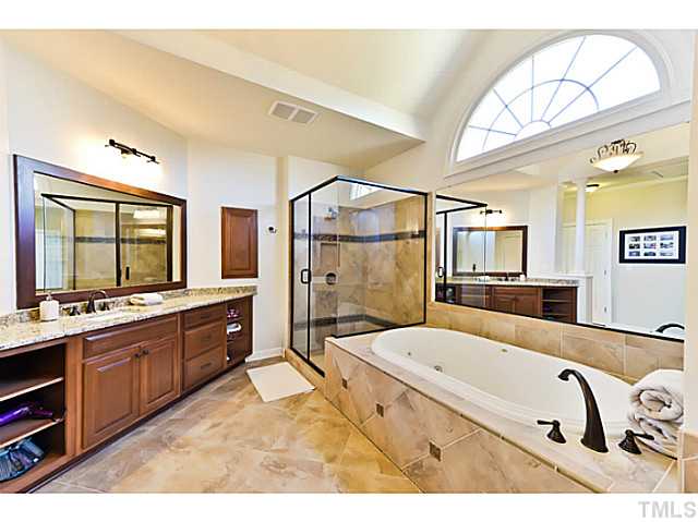 11806 Lowery Ridge Drive Raleigh, NC 27614 - Photo 13 of 25 a spacious bathroom with a tub sink shower and mirror