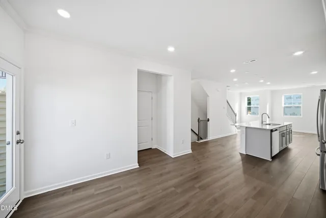a view of empty room with a fireplace and windows